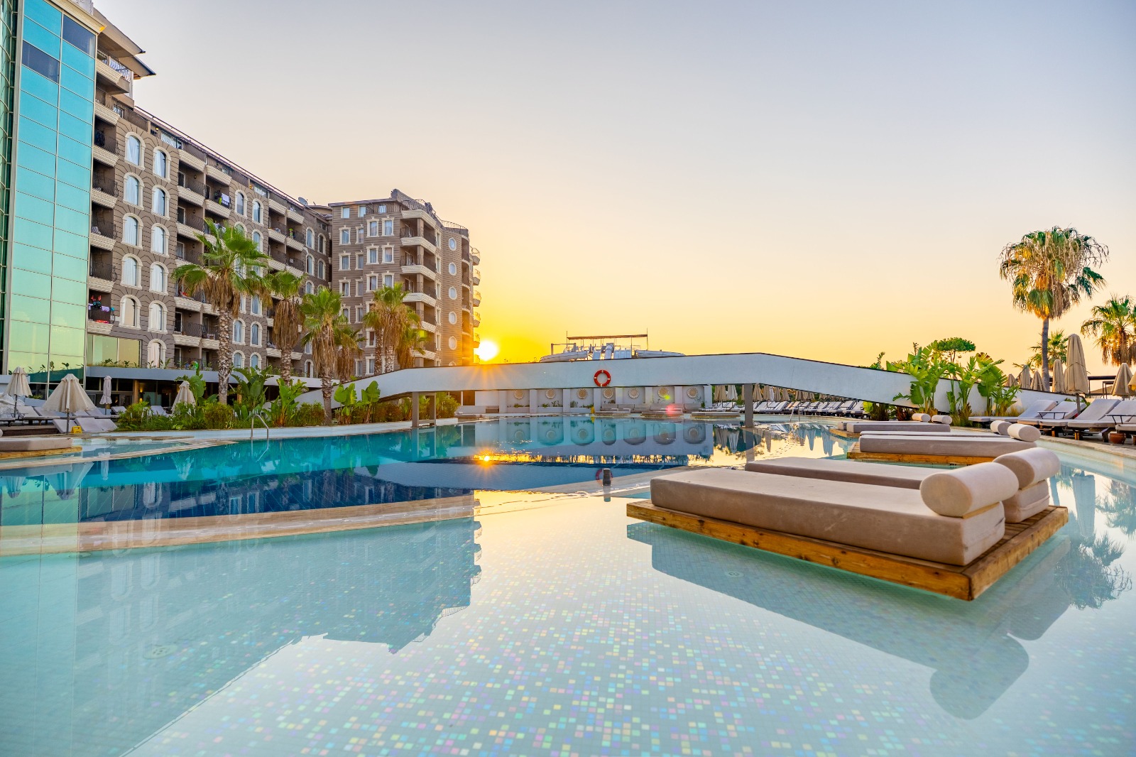 Resort pool glowing at sunset