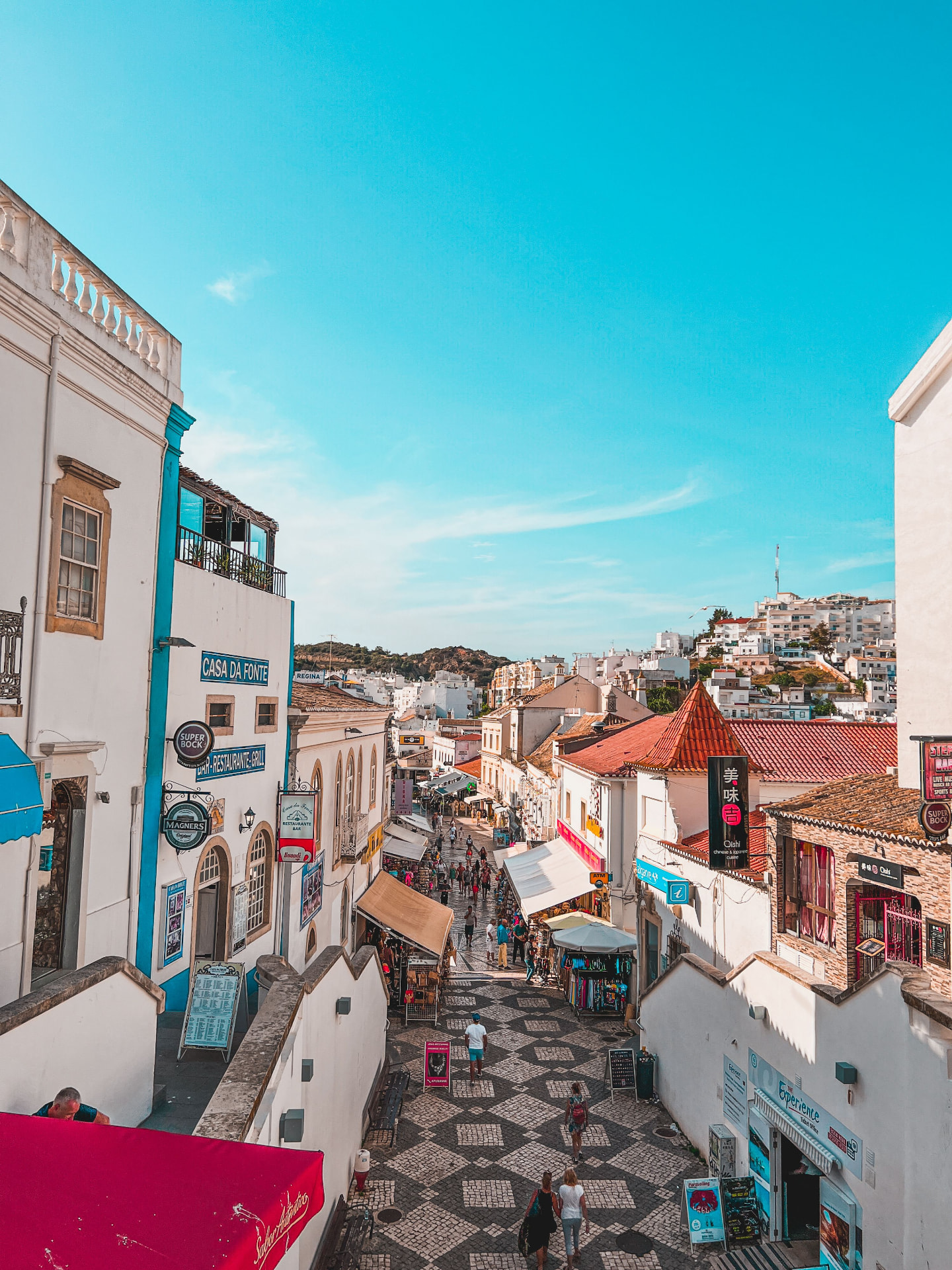 Colourful old-town street beneath a bright blue sky